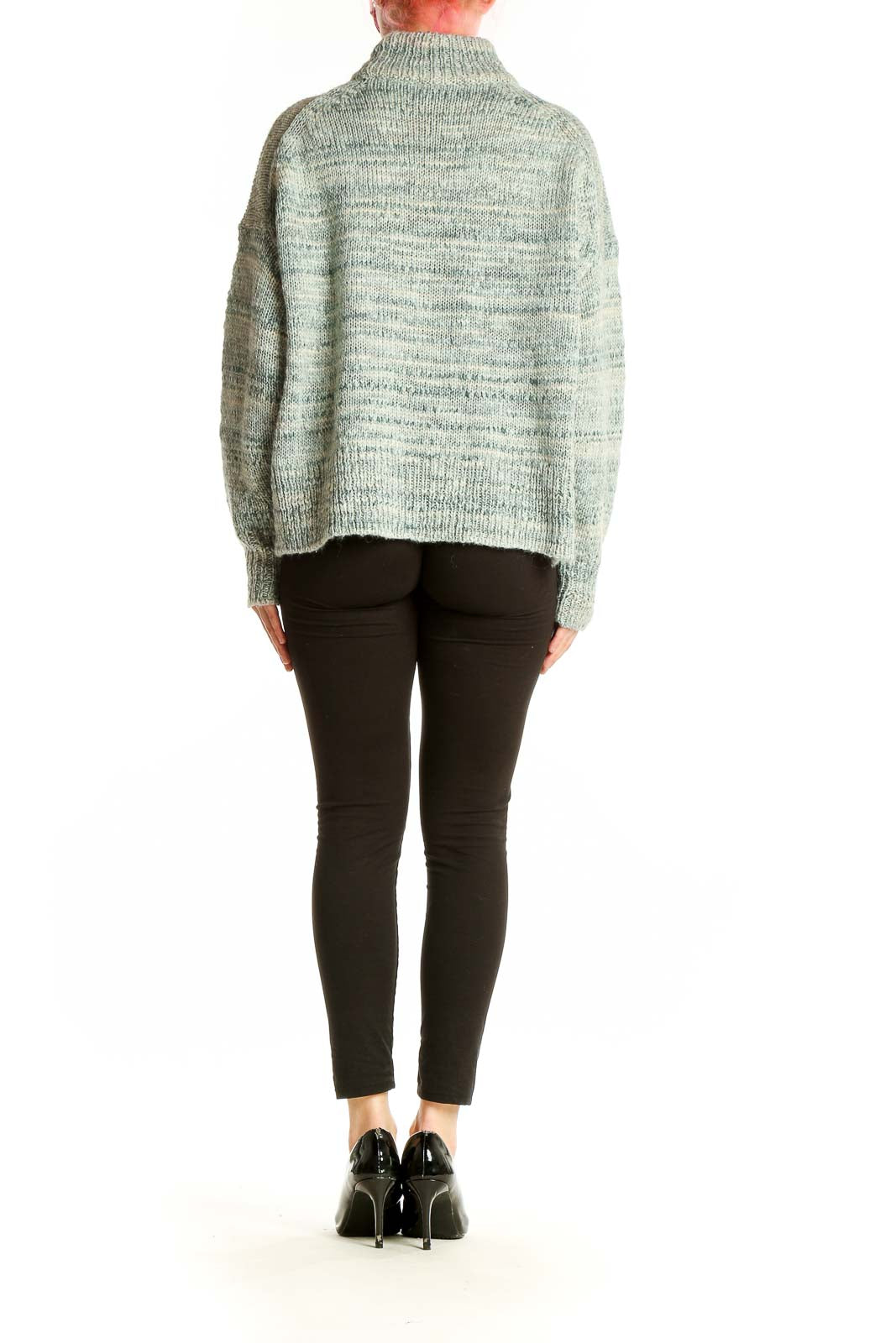 Side view of J.Crew mint green marled turtleneck sweater on model with black pants