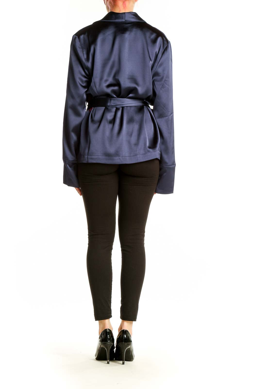 Side view of model wearing Carbon 38 navy satin wrap jacket