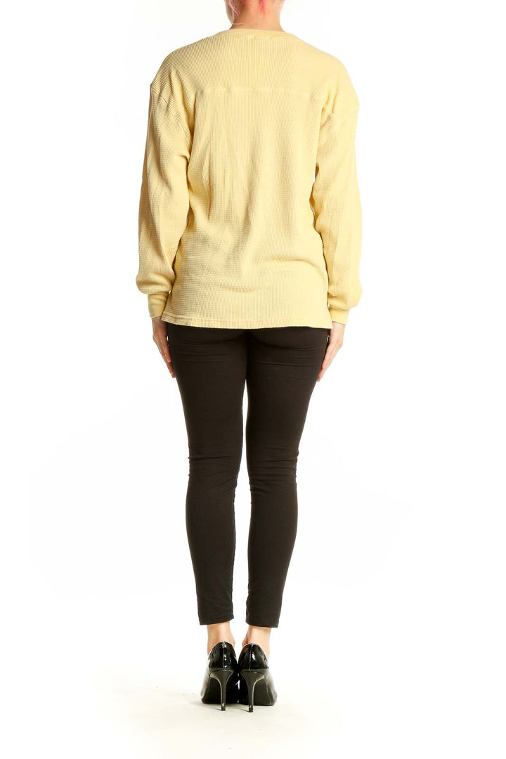 Back view of yellow V-neck ribbed long sleeve top from Tna
