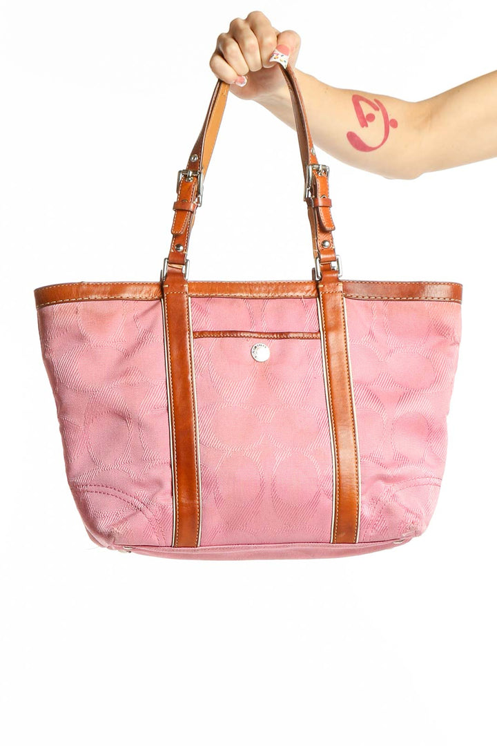 Front view of pink leather Coach tote bag with tan trim
