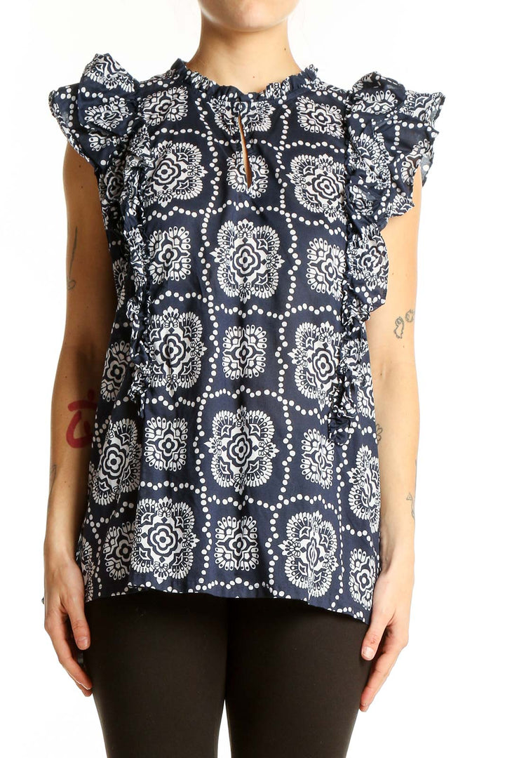 Front view of Ann Taylor navy blouse with white floral print and ruffle sleeves