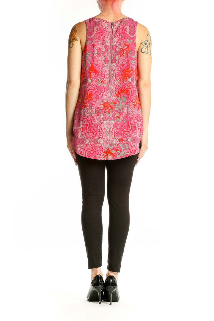 Side view of Cabi pink paisley sleeveless tunic top on model