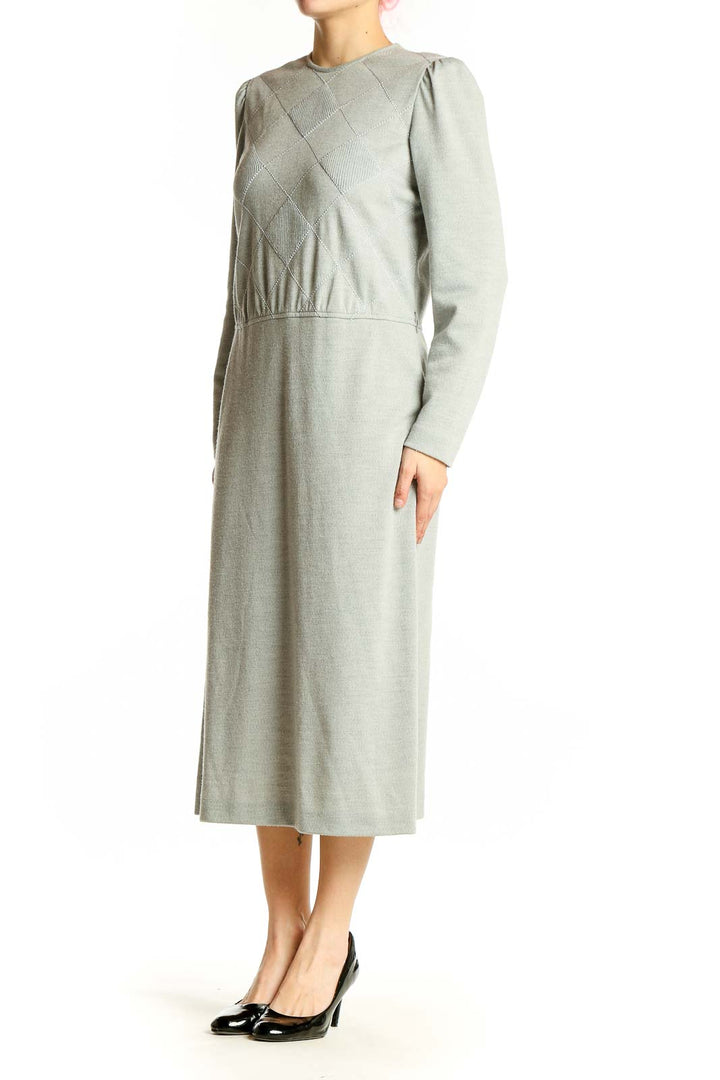 Front view of sage green Leslie Fay midi dress with diamond-patterned bodice and long sleeves