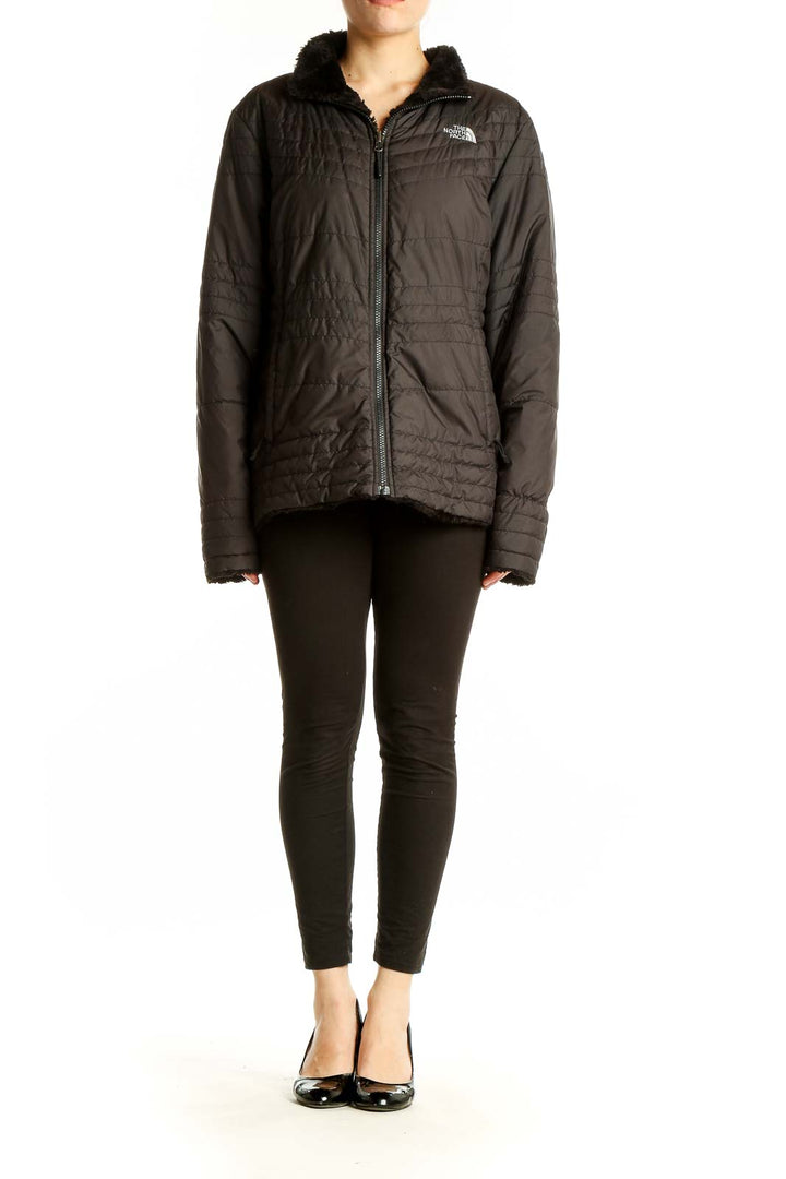 Front view of black quilted The North Face jacket with sherpa-lined collar