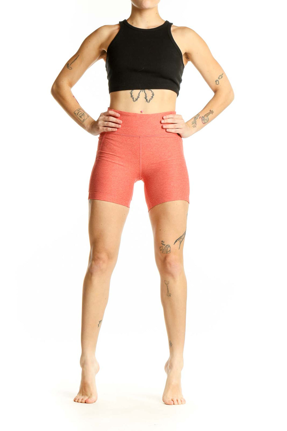 Front view of coral high-waisted workout shorts from Outdoor Voices
