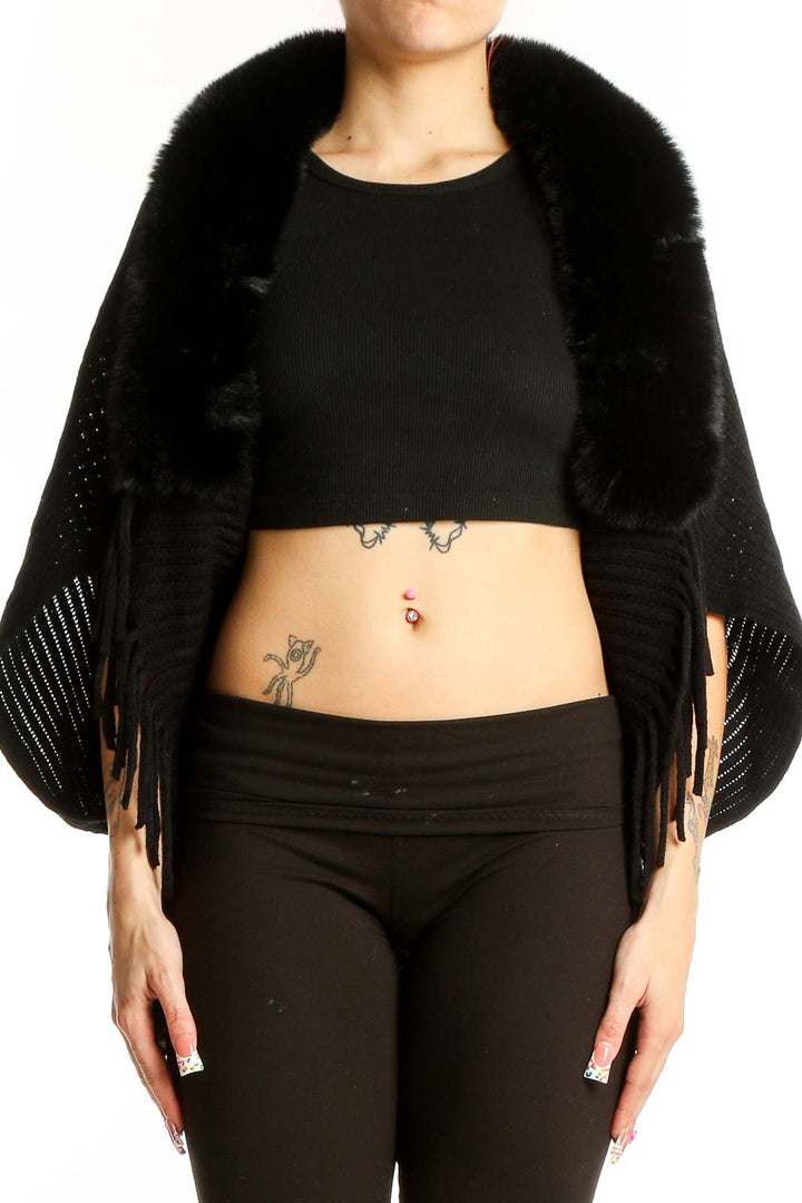 Front view of black knit shawl with fur collar and fringe detail