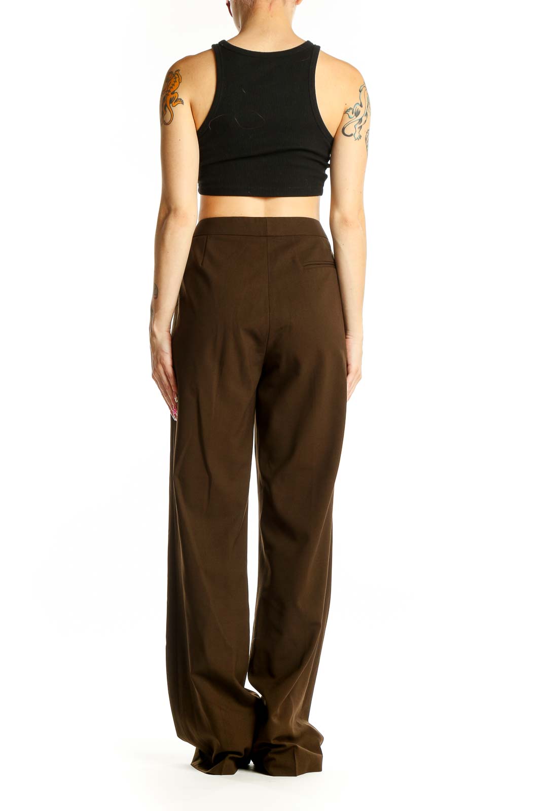 Side view of woman wearing brown wide-leg trousers with black top