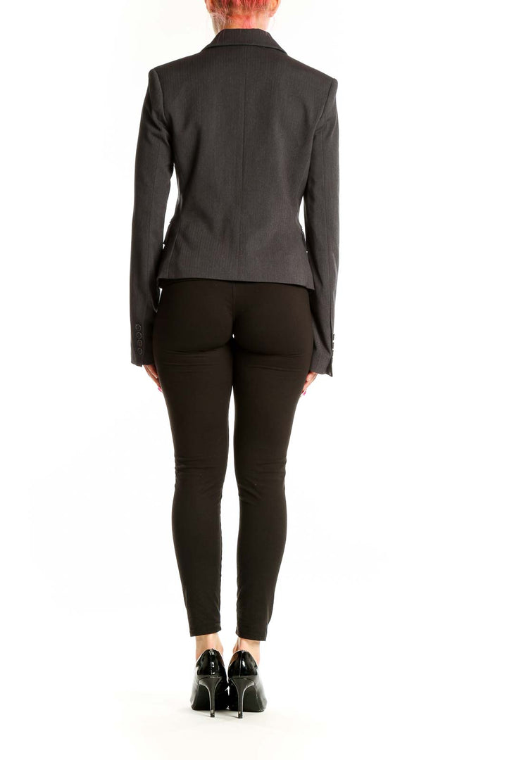 Side view of gray BCBG MaxAzria blazer showing tailored fit and long sleeves