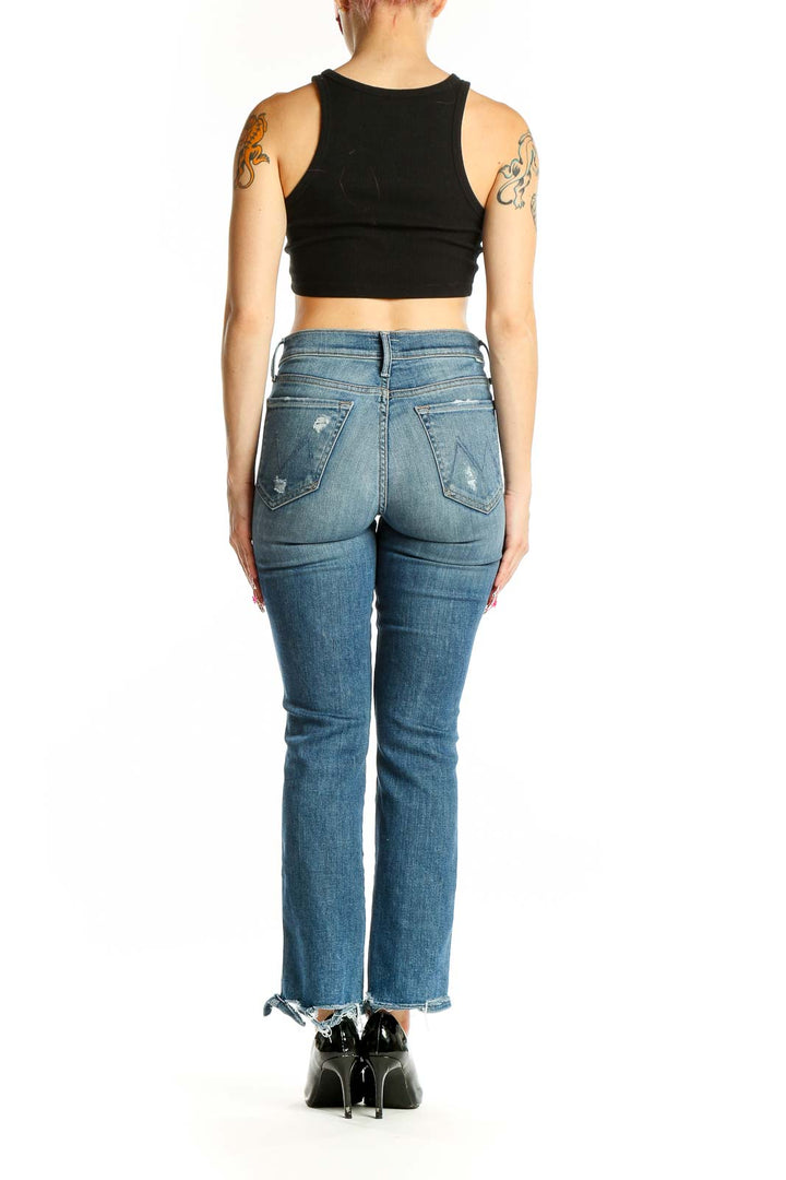Back view of Mother blue flare jeans showing frayed hem