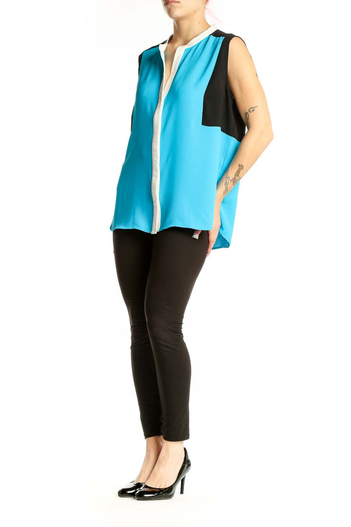 Front view of Nine West turquoise color-block sleeveless blouse with white placket