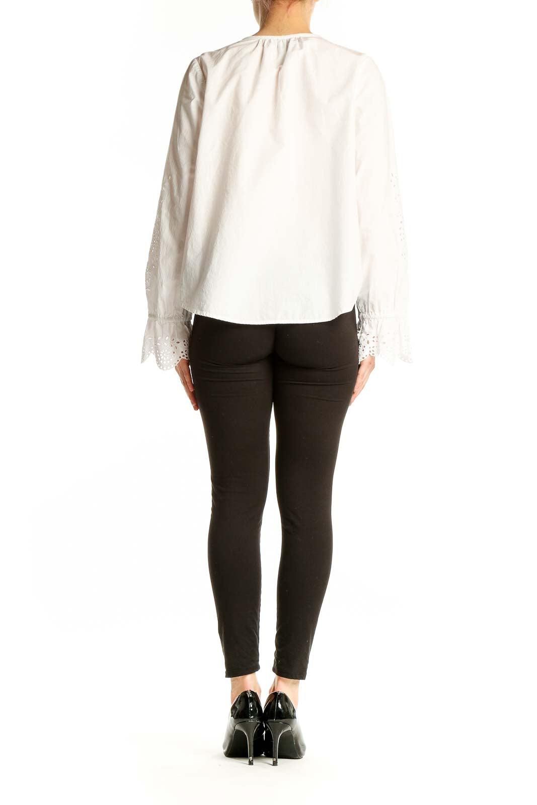 Side view of Joie white blouse showcasing eyelet lace bell sleeves