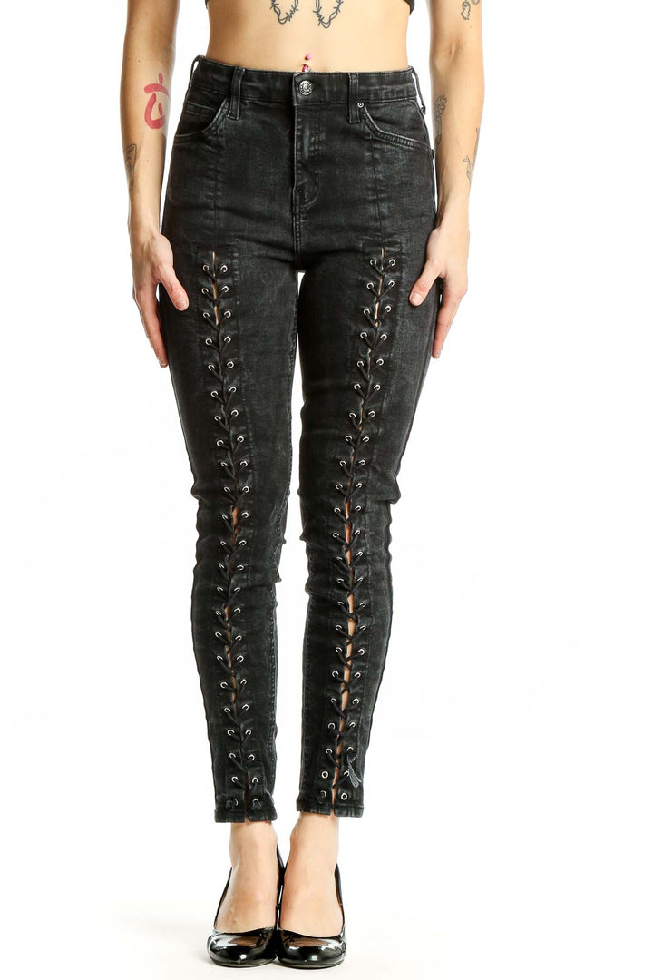 Front view of Topshop black lace-up skinny jeans with edgy details
