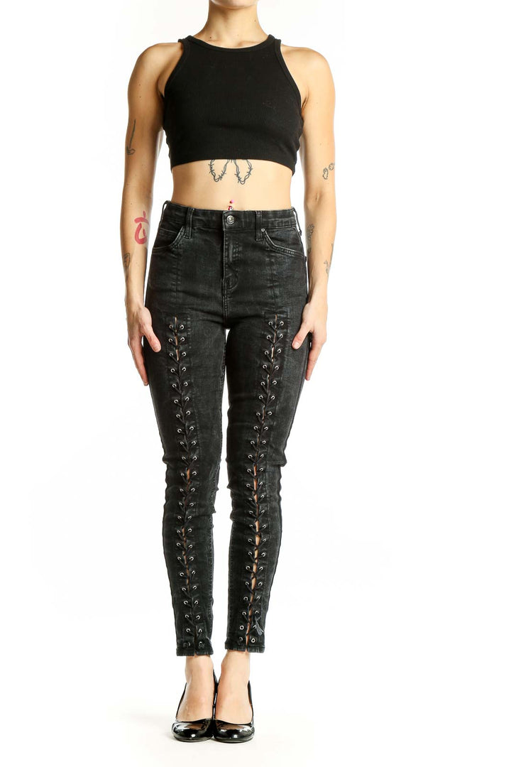 Front view of Topshop black lace-up skinny jeans with edgy details