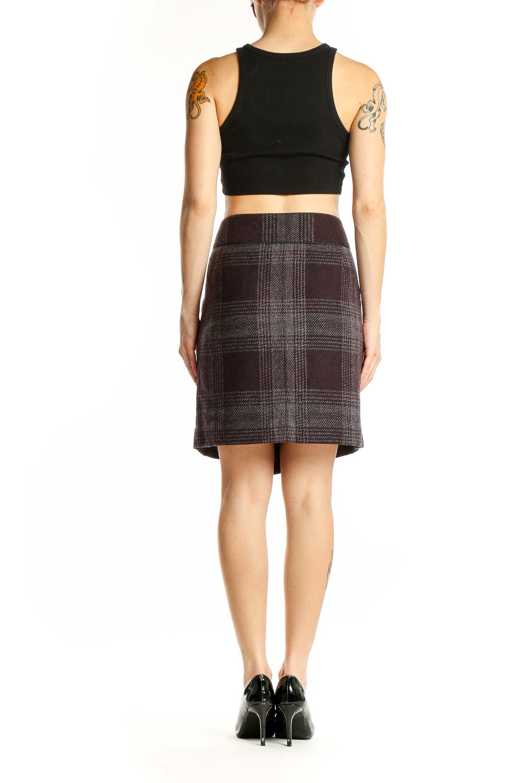 Side view of model wearing Ann Taylor LOFT brown plaid mini skirt with black top