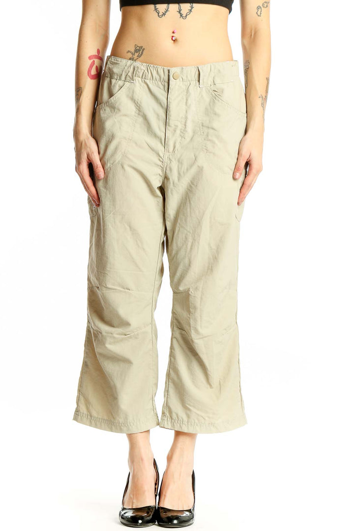 Front view of beige Columbia nylon cropped cargo pants on model