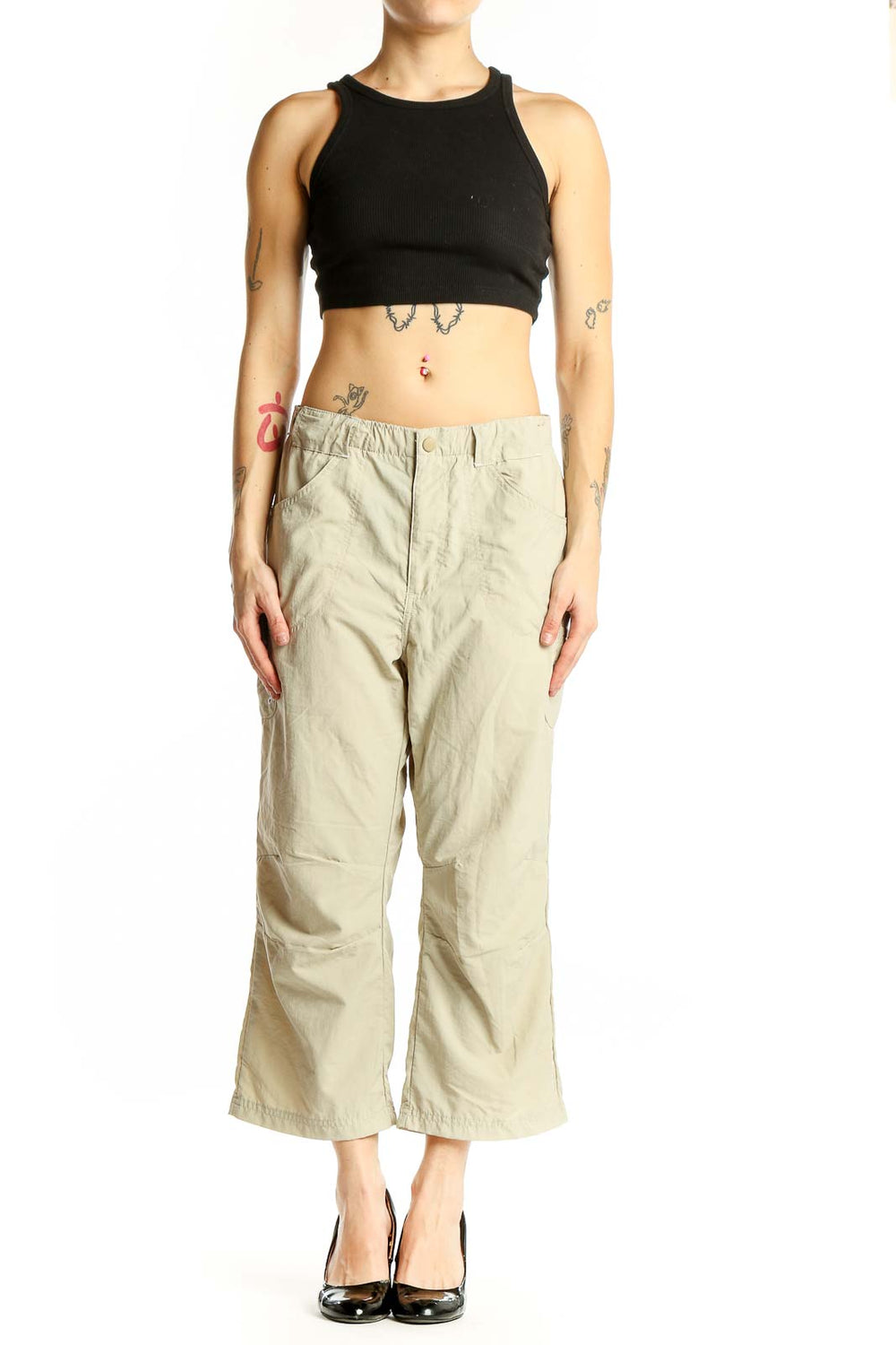 Front view of beige Columbia nylon cropped cargo pants on model
