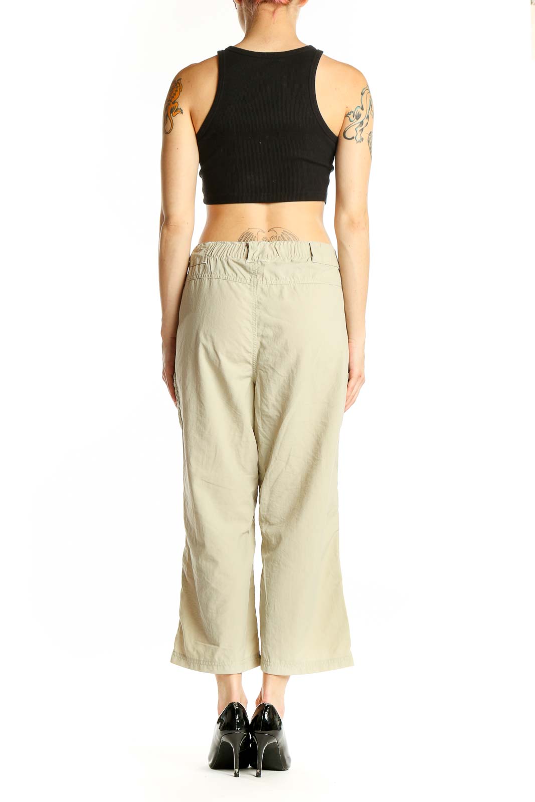 Back view of beige Columbia nylon cropped cargo pants on model