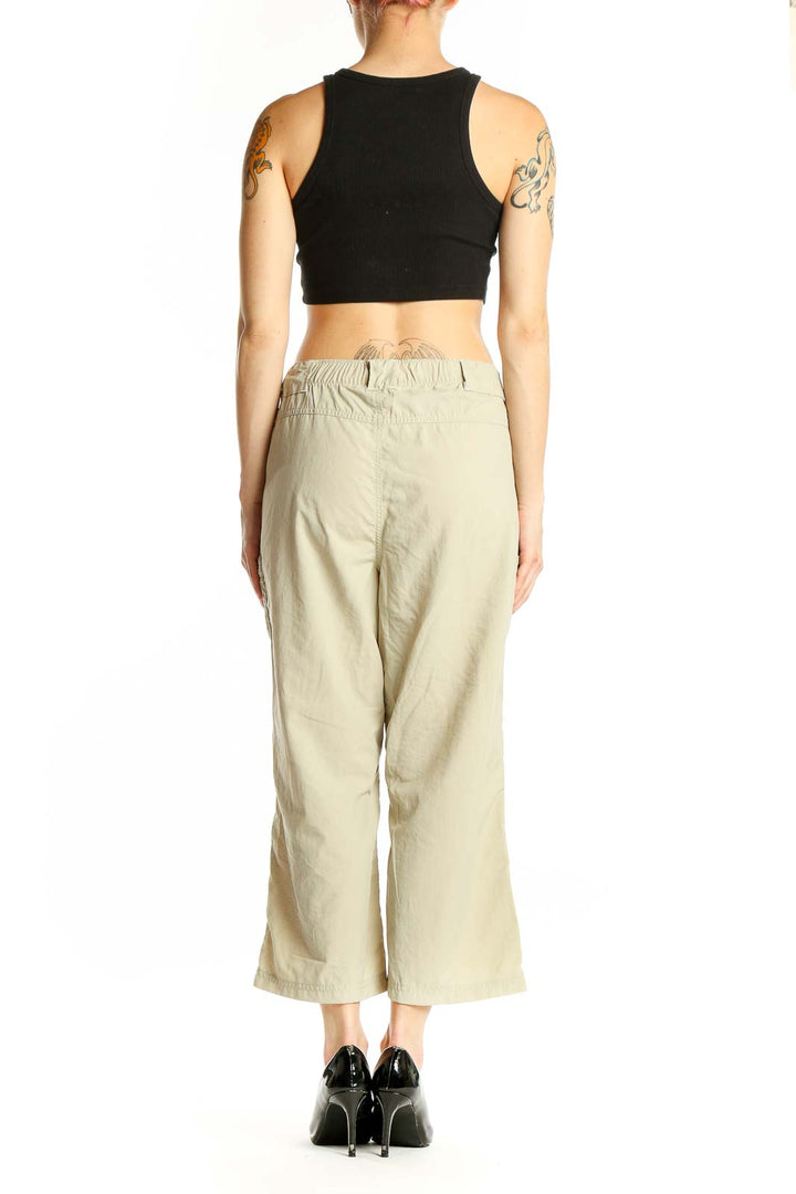 Back view of beige Columbia nylon cropped cargo pants on model