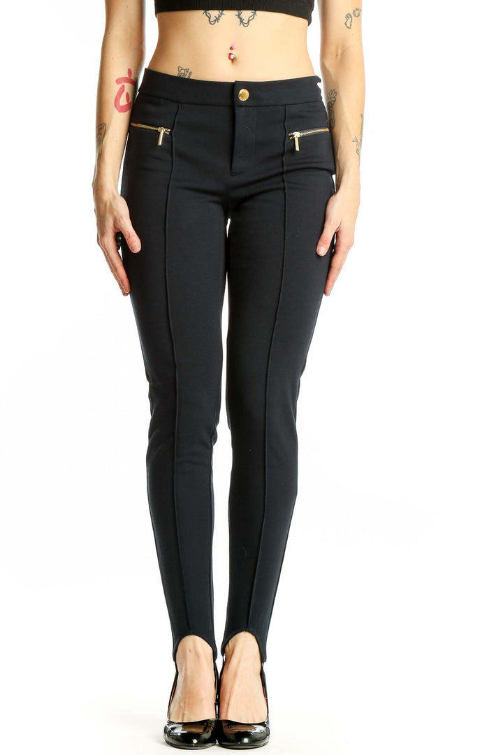 Front view of Michael Kors black stirrup pants with gold-toned zip pockets
