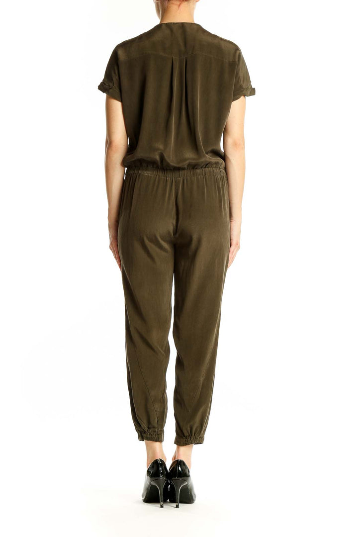 Side view of olive green Vince jumpsuit showing relaxed fit and tapered legs