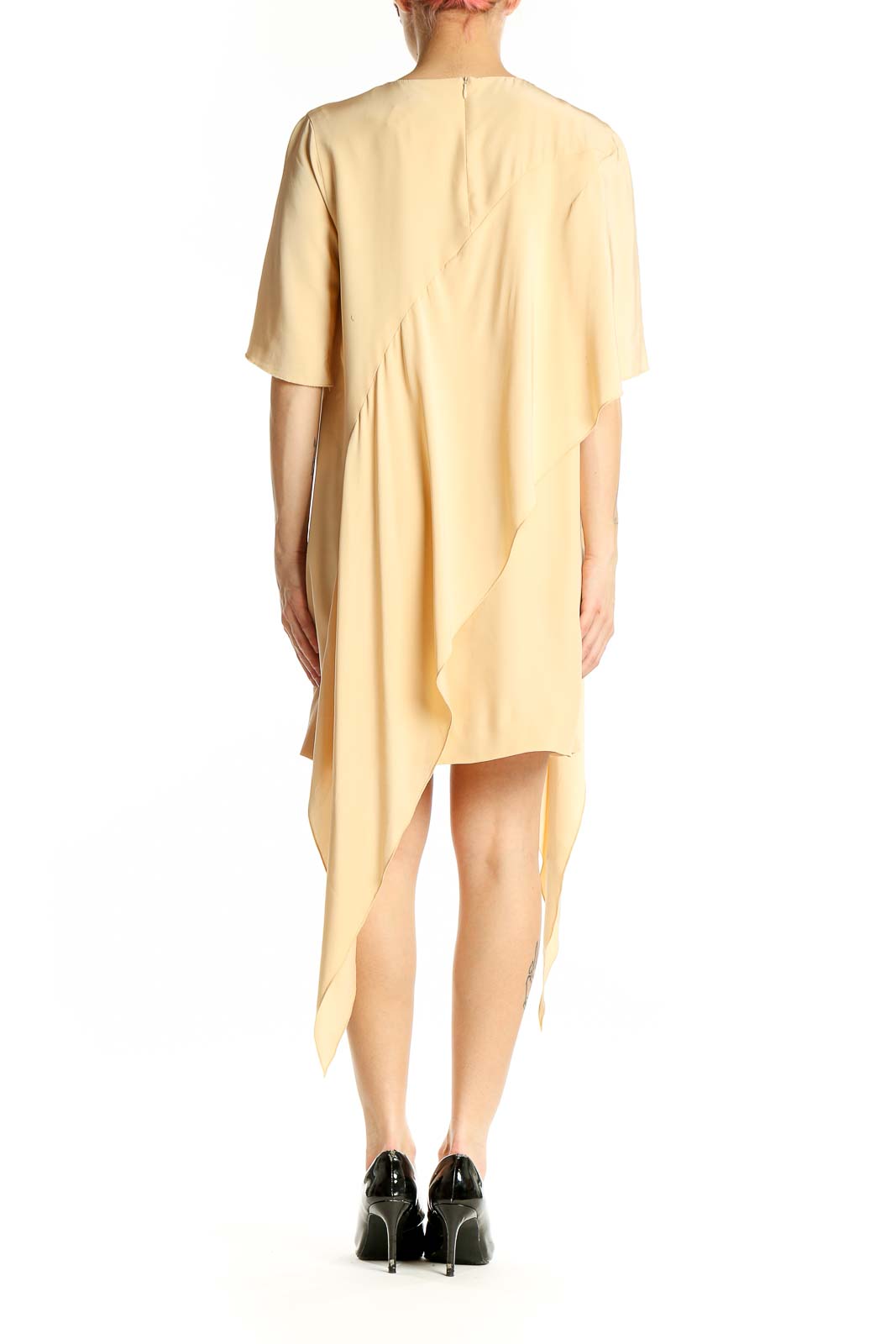 Side view of C/MEO Collective cream silk asymmetrical cocktail dress showing drape