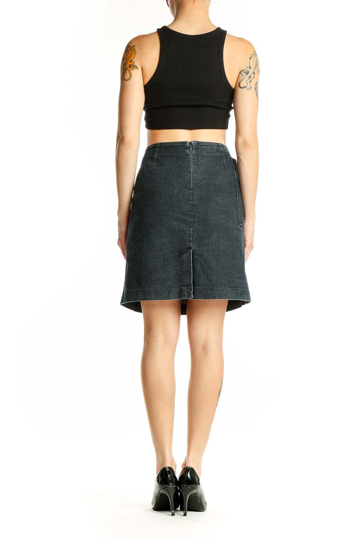 Side view of model wearing Armani Jeans dark blue denim A-line skirt with black top