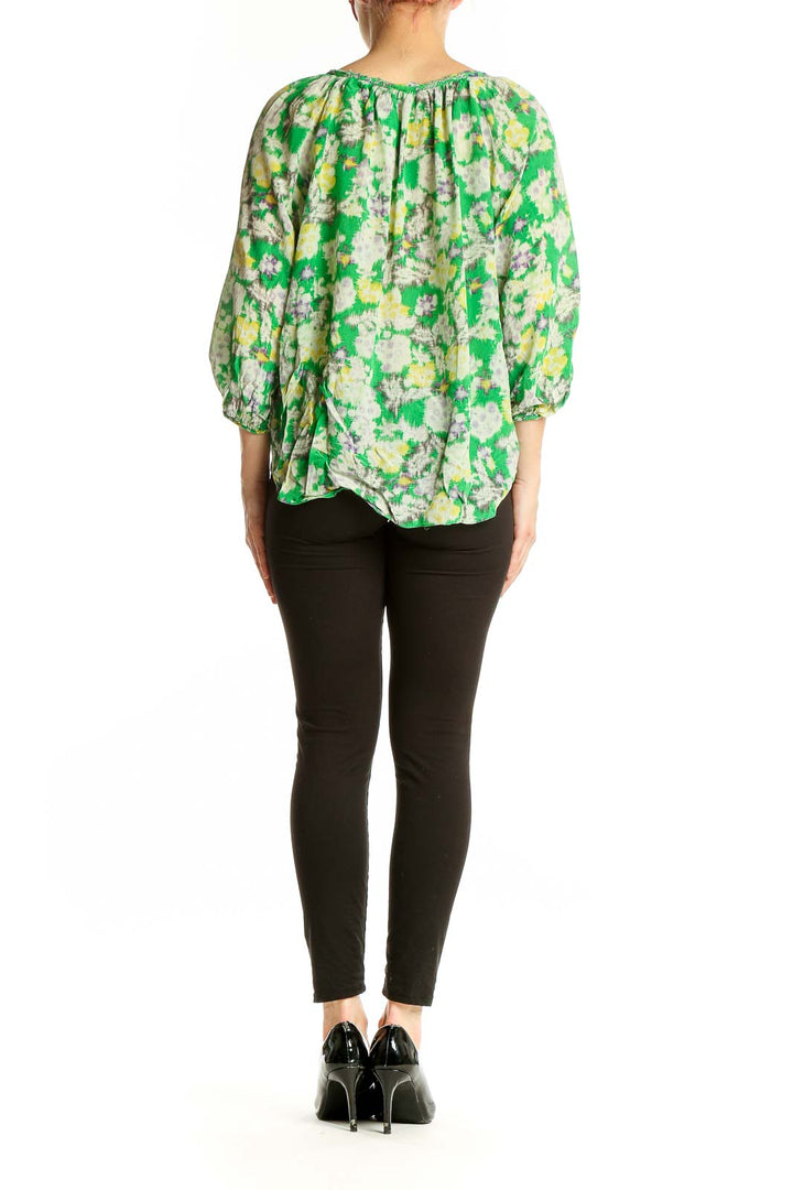 Side view of Rebecca Taylor green floral silk peasant blouse showing voluminous sleeves