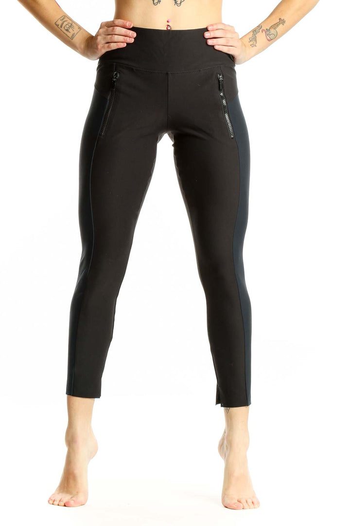 Front view of Athleta black high-waisted leggings with zip pockets