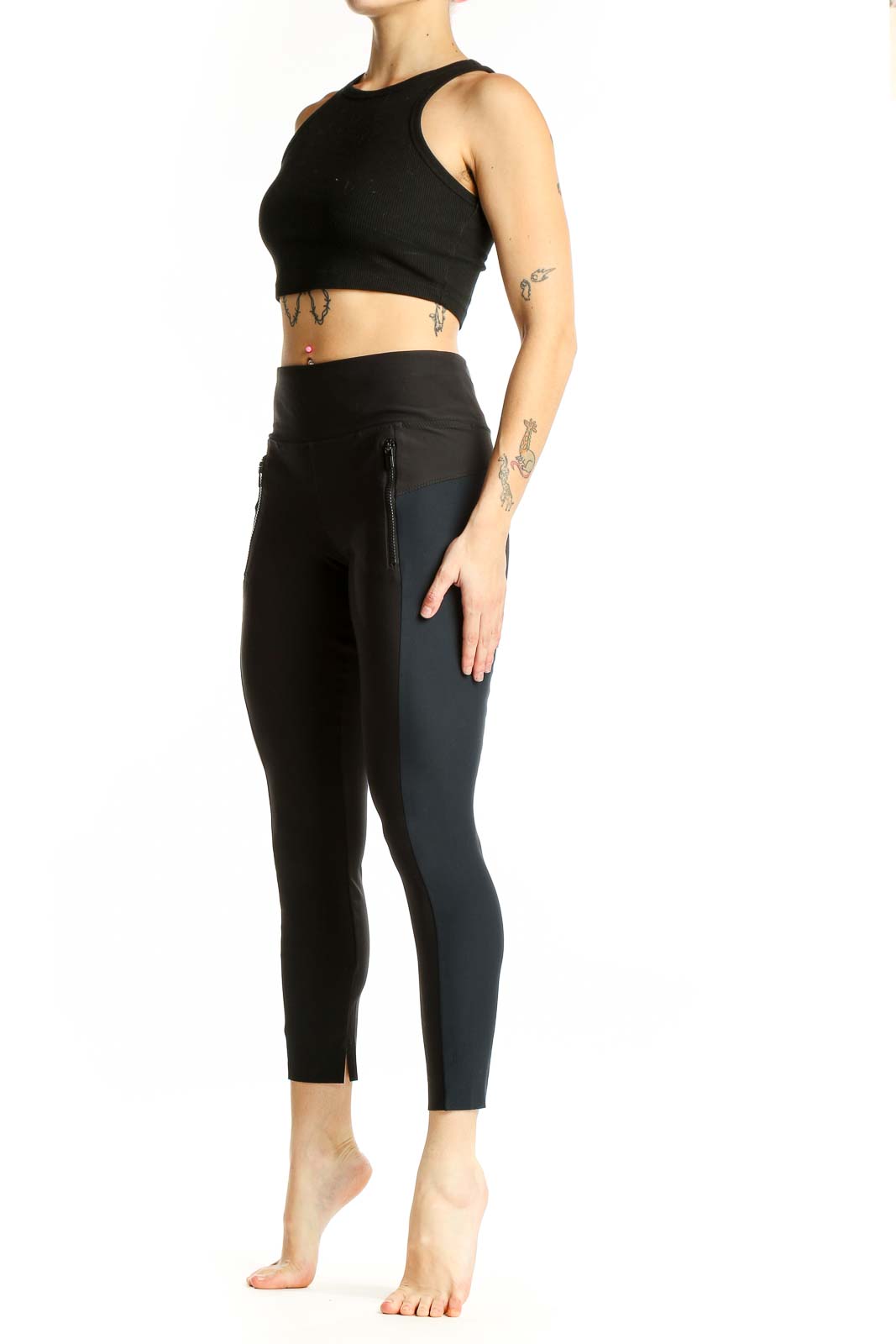 Front view of Athleta black high-waisted leggings with zip pockets