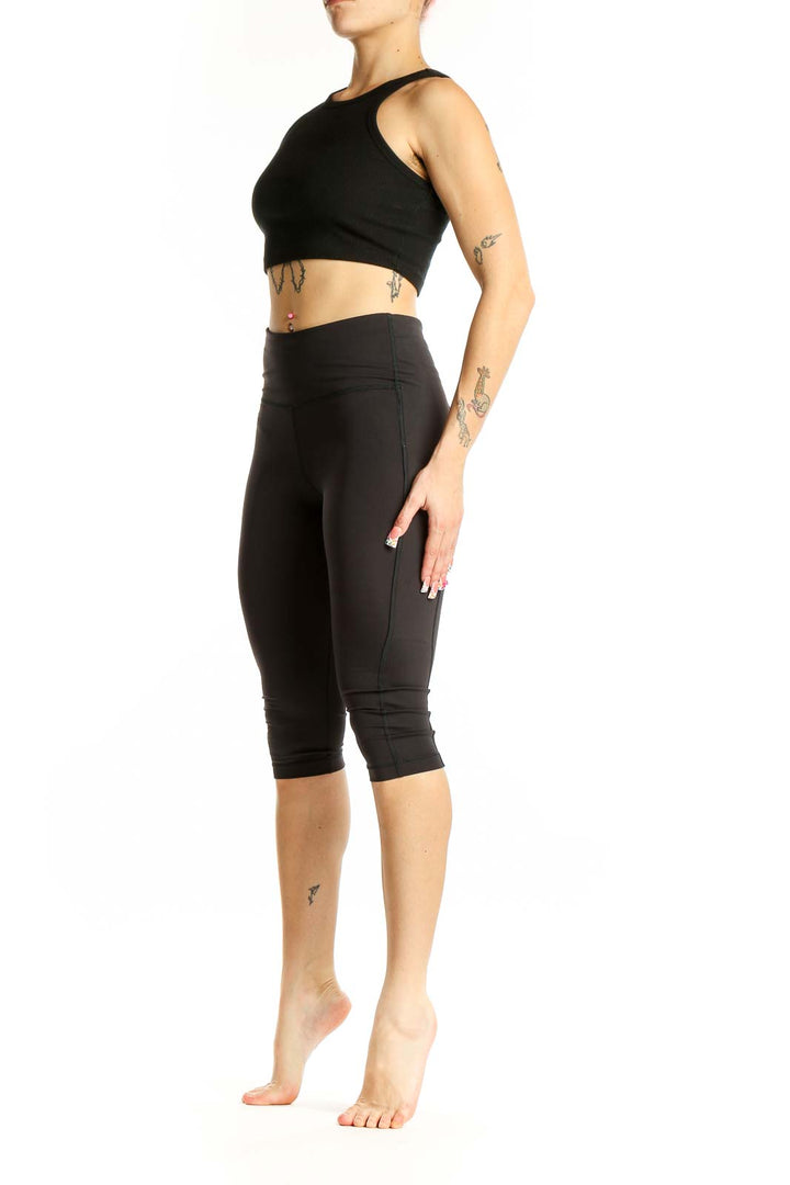 Front view of black Athleta high-waisted capri leggings