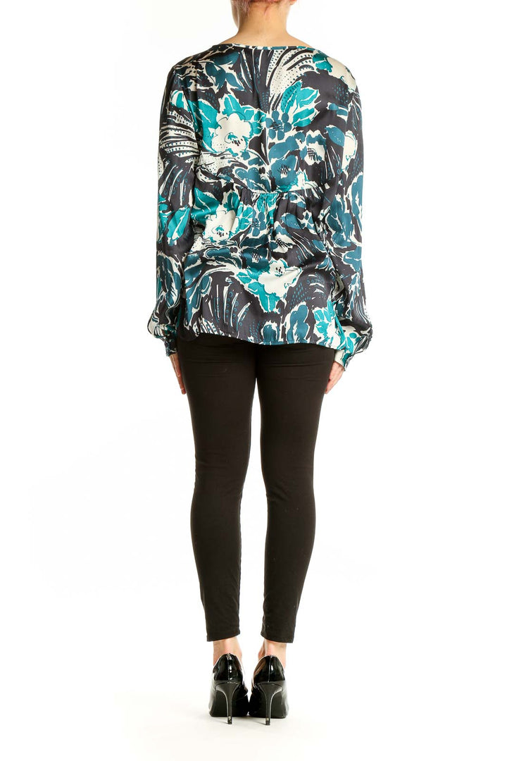 Side view of Sanctuary teal floral print long sleeve blouse on model