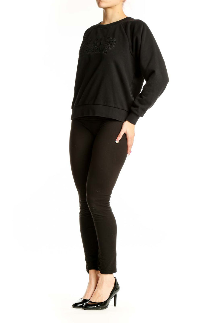 Front view of black GAP logo sweatshirt with tonal design