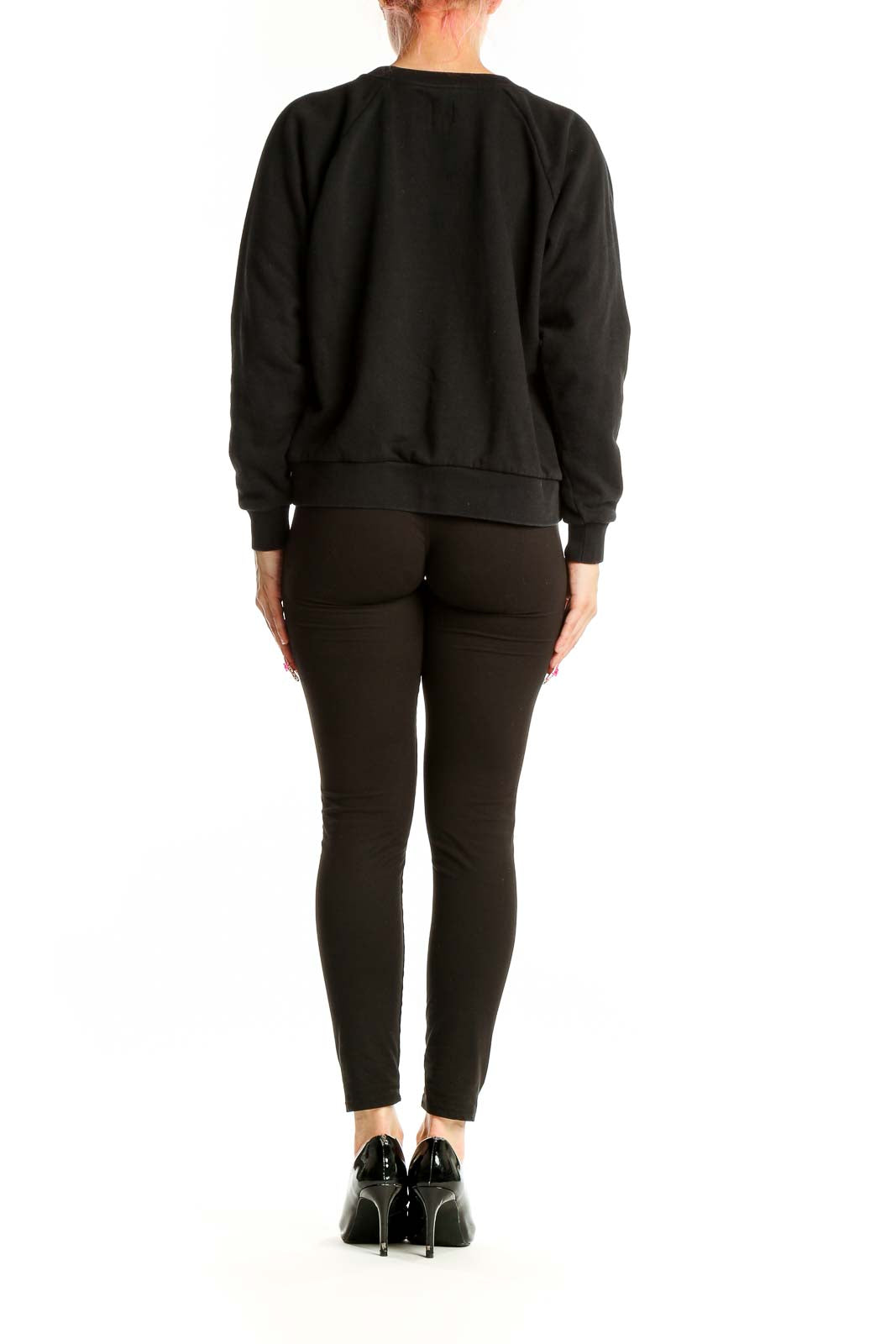 Side view of woman wearing black GAP logo sweatshirt