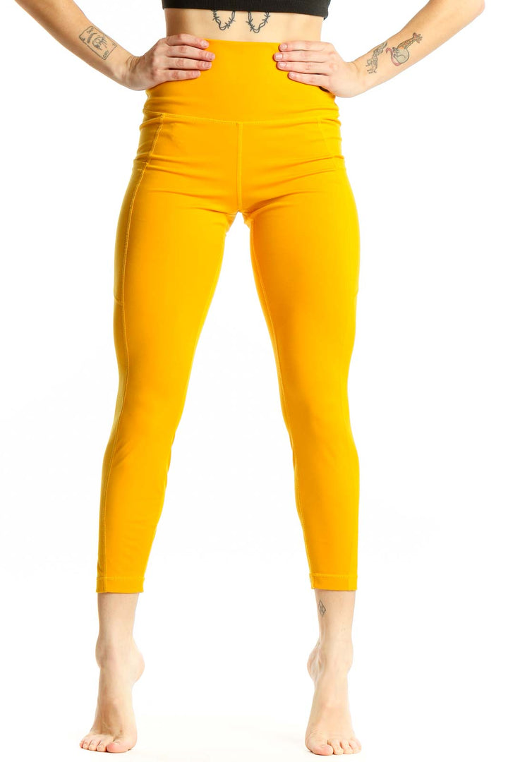 Front view of yellow high-waisted compression leggings from 90 Degree