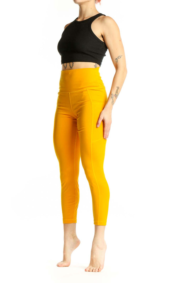 Front view of yellow high-waisted compression leggings from 90 Degree