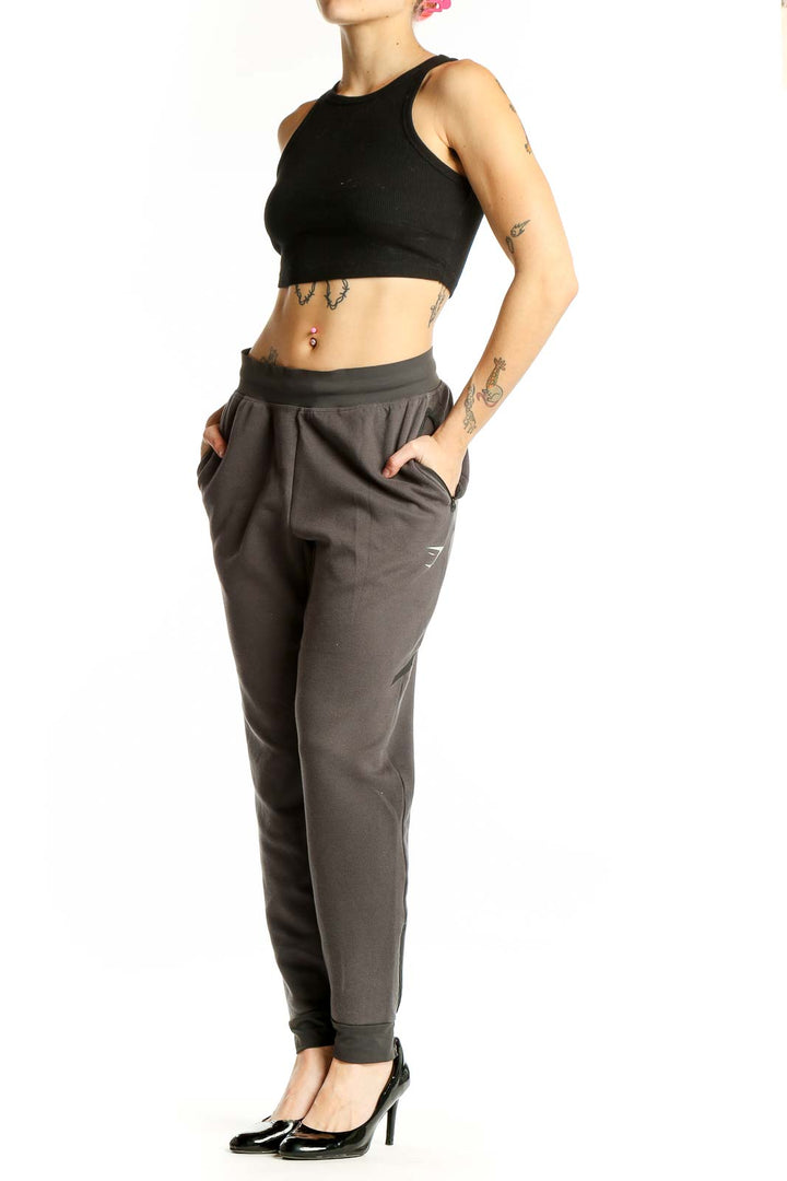 Front view of gray Gymshark jogger pants with tapered design