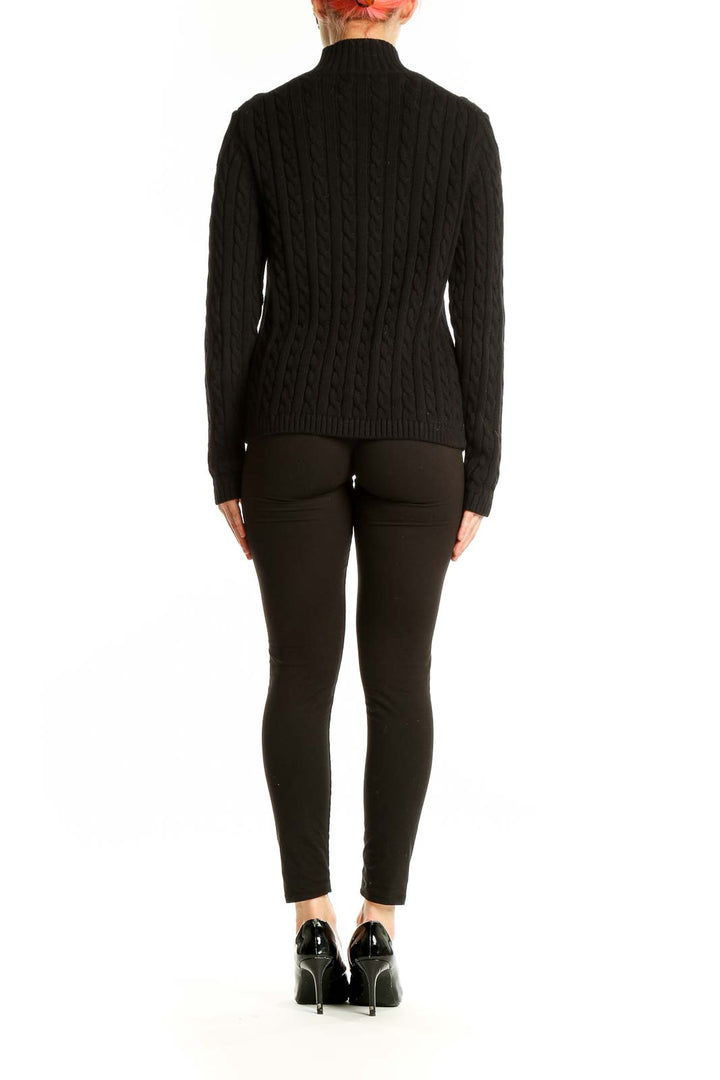 Side view of woman wearing L.L.Bean black cable knit zip-up sweater