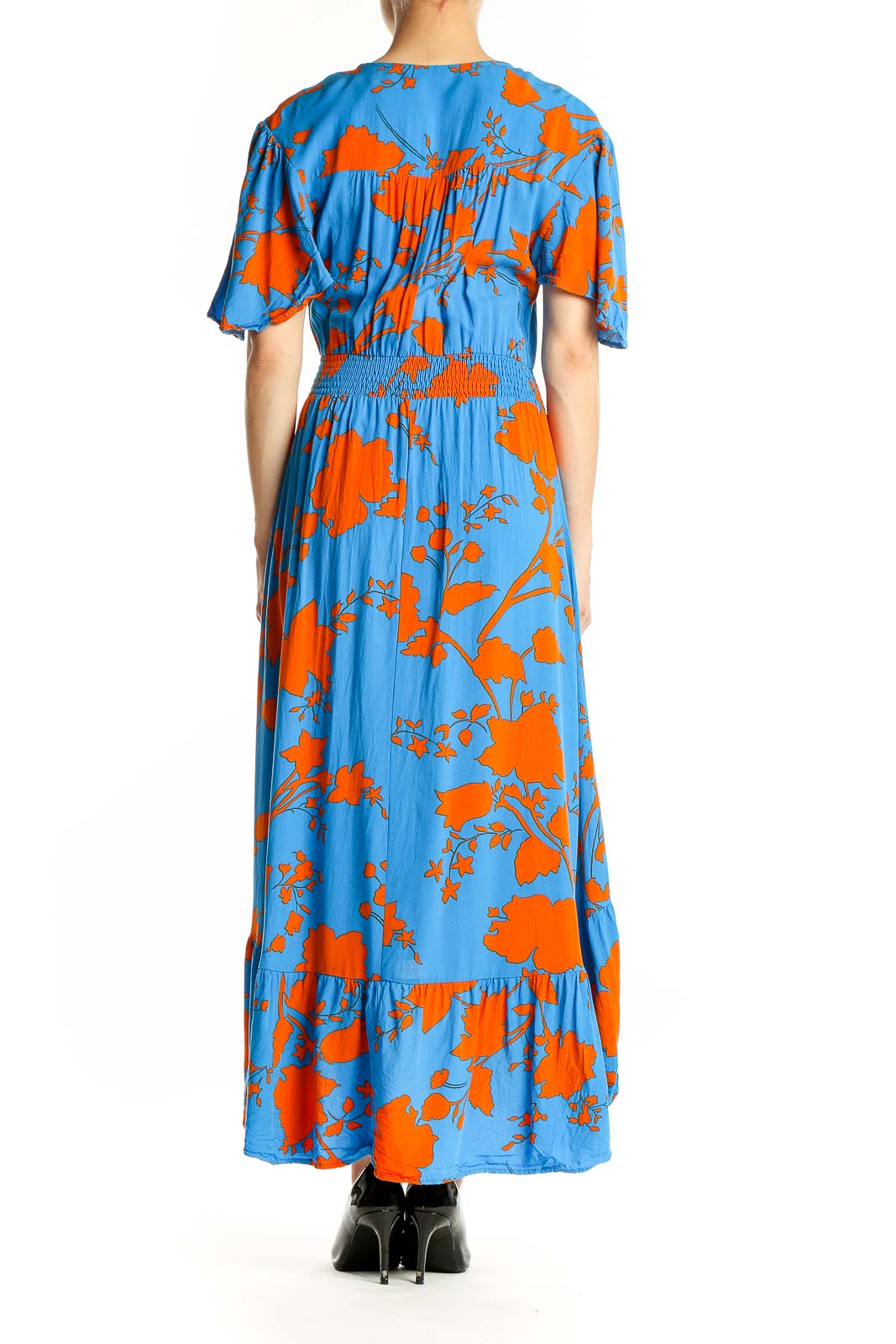 Side view of blue and orange floral maxi dress showing high-low hemline