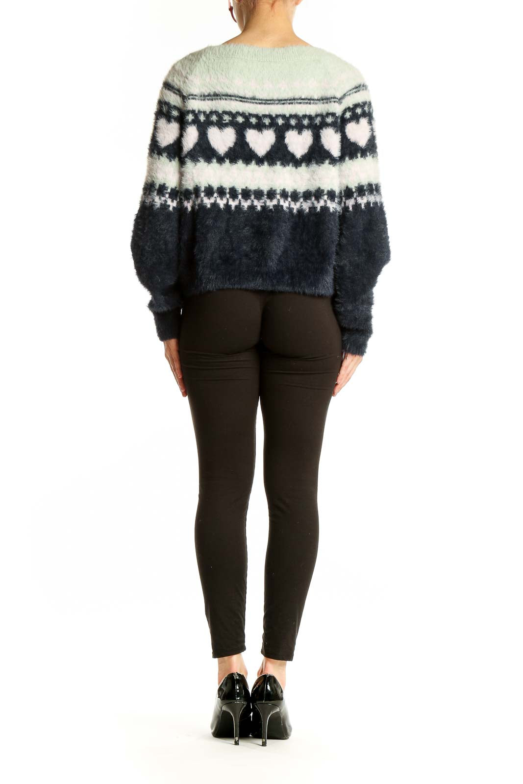 Side view of model wearing Victoria's Secret navy and white heart pattern fuzzy sweater