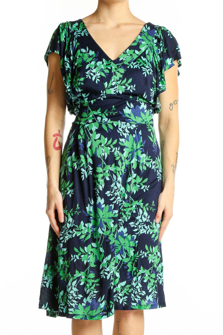 Front view of Boden navy midi dress with green floral print and flutter sleeves