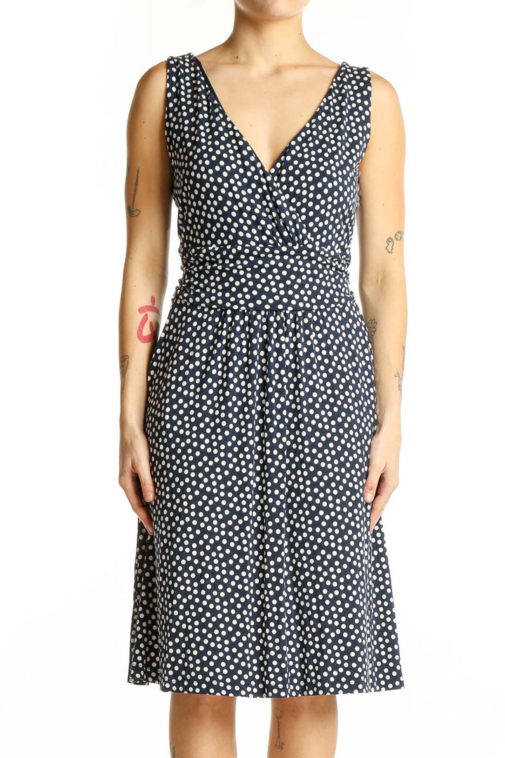 Front view of Boden navy polka dot sleeveless wrap dress