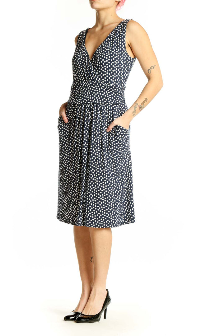 Front view of Boden navy polka dot sleeveless wrap dress