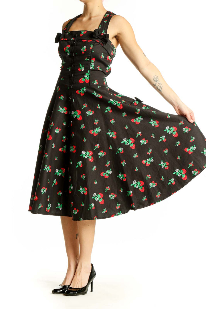 Front view of Hell Bunny black cherry print swing dress with square neckline and bow detail