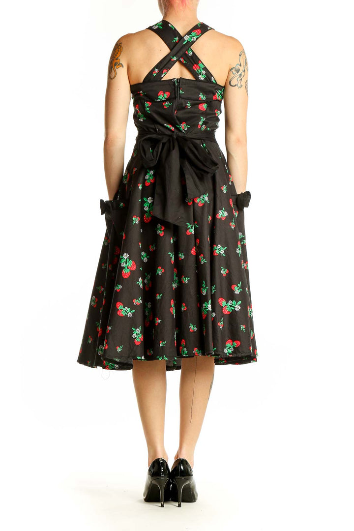 Side view of Hell Bunny black cherry print swing dress showing flared midi skirt