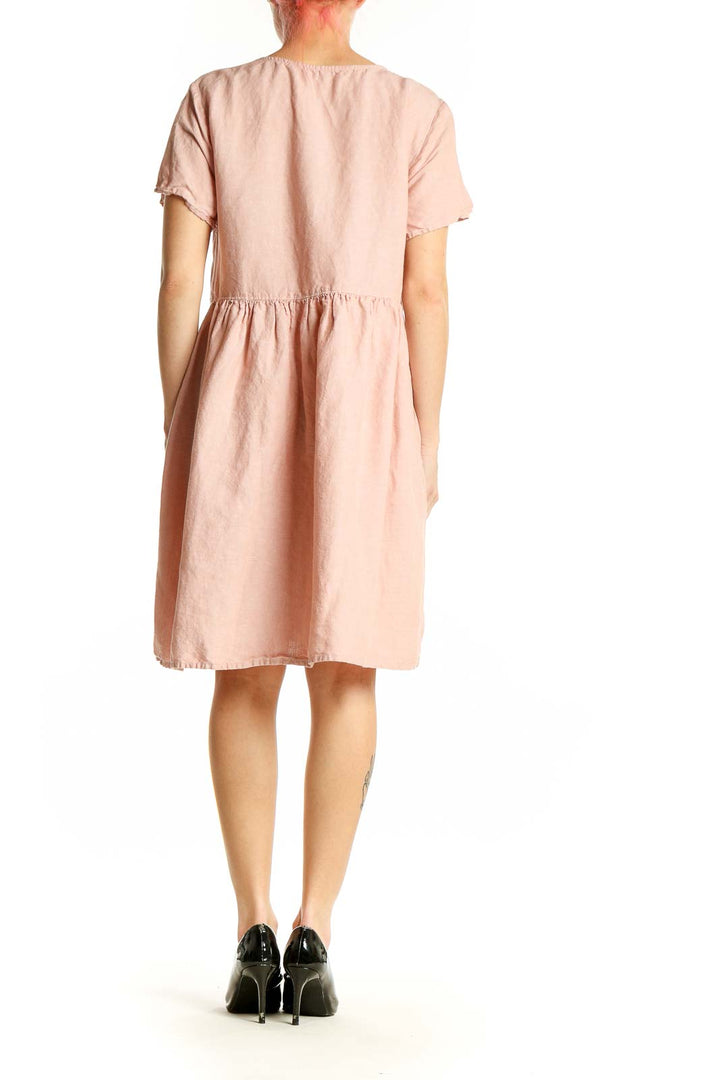Side view of Madewell blush pink midi dress showing relaxed fit and length