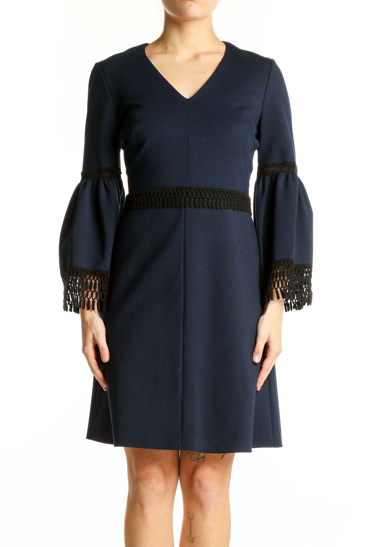 Front view of Kobi Halperin navy cocktail dress with bell sleeves and black fringe