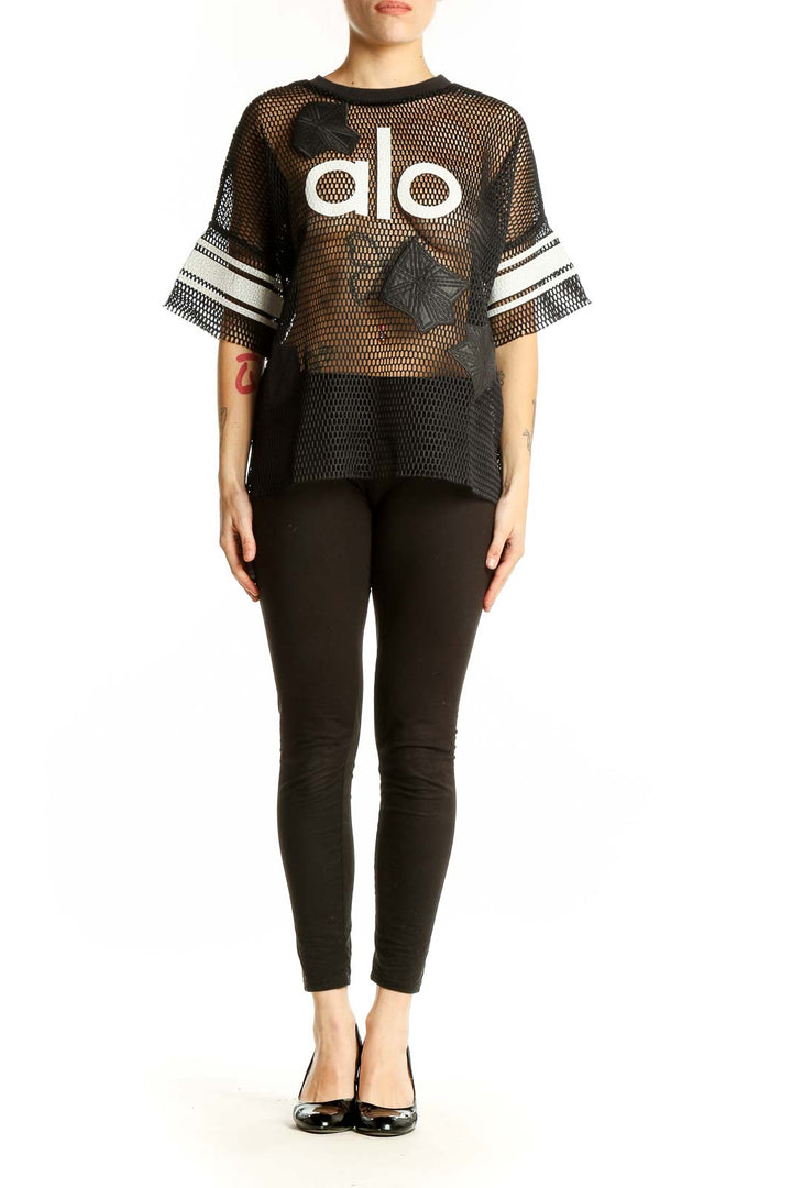 Front view of black mesh Alo activewear top with logo