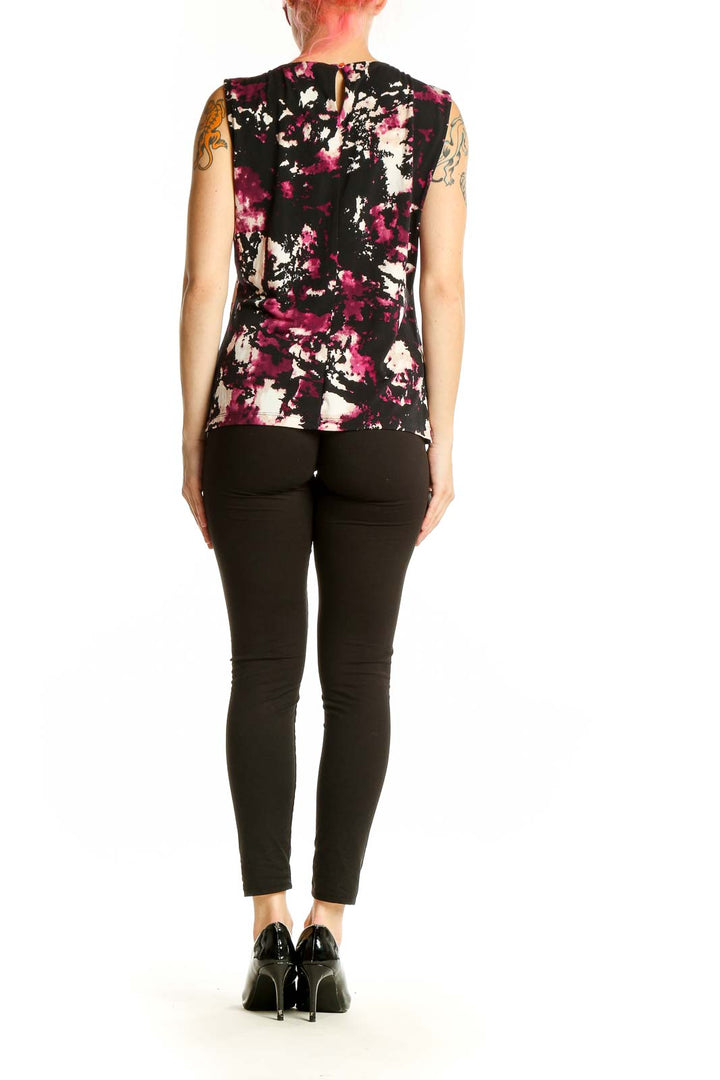 Side view of model wearing Calvin Klein abstract print sleeveless top with black pants