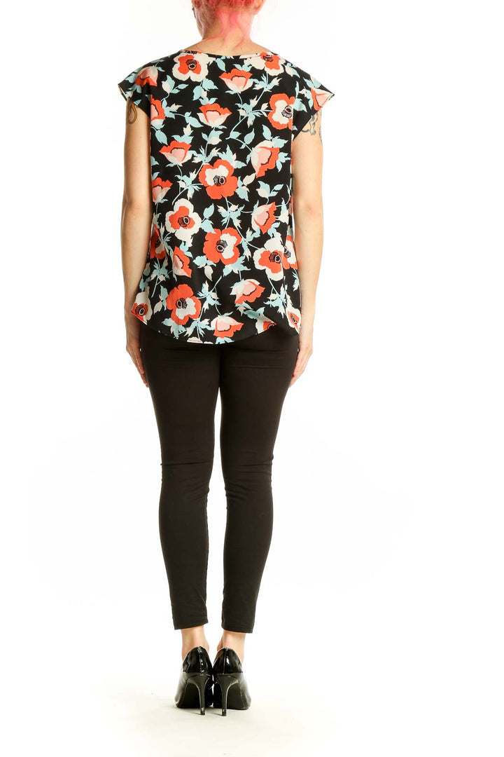 Back view of Talbots black floral print cap sleeve blouse on model