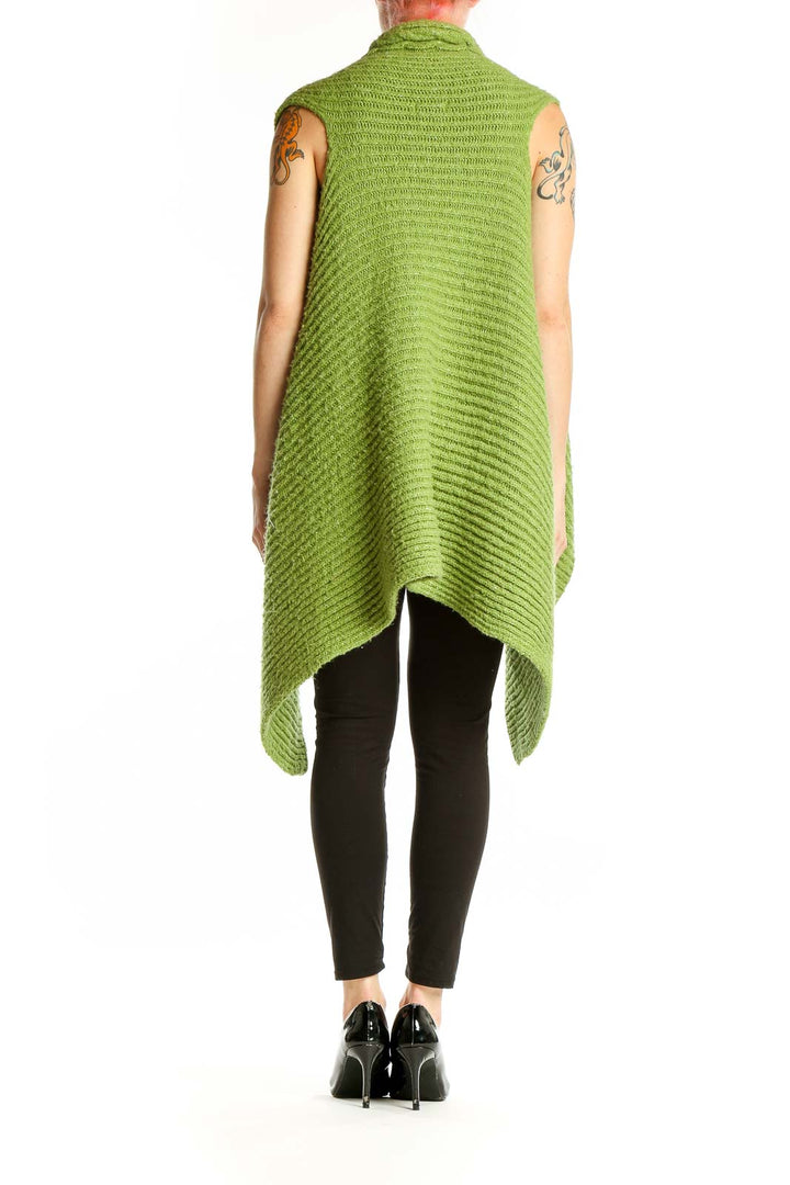 Side view of BCBG MaxAzria green sleeveless cable knit cardigan on model